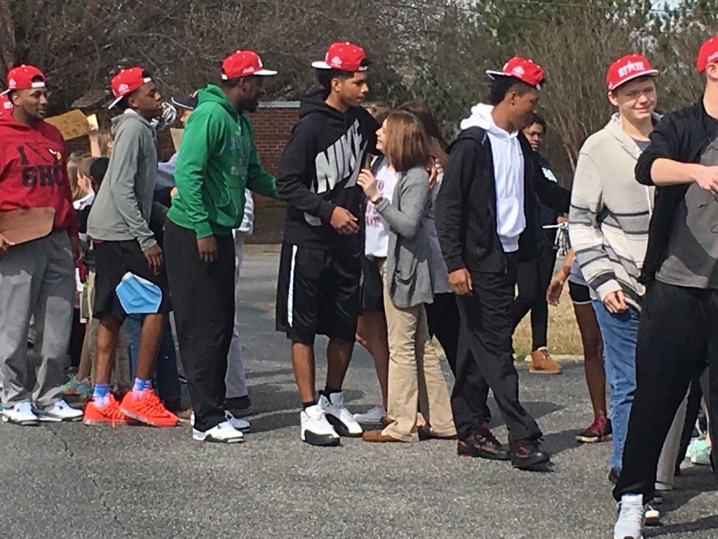 Class 1A Final Four MVP Diante Wood (center) and his teammates greet the fans upon arriving from Birmingham with their second state championship. On the cover, coach Ralph Graves dances with some of the younger fans.