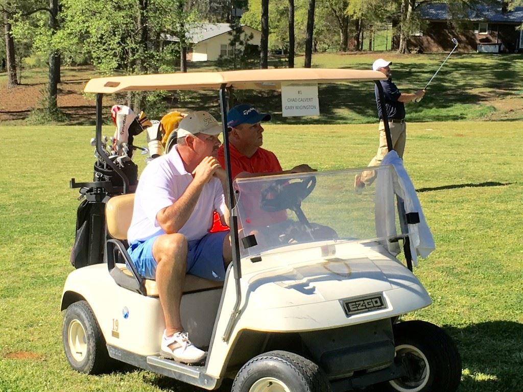 Chad Calvert (cart driver) and Gary Wigington battled the whole day out of the same cart before Calvert birdied three of the last four holes to win the Indian Oaks Championship. In this image they hold position as Jonathan Pate hits from the 11th fairway.