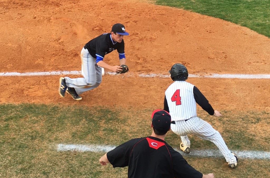 White Plains third baseman Andrew Norred chases down Cleburne County's Kade Clark (4), who had overrun the bag in the second inning. On the cover, Tigers winning pitcher Jordan Brown looks in for a sign.