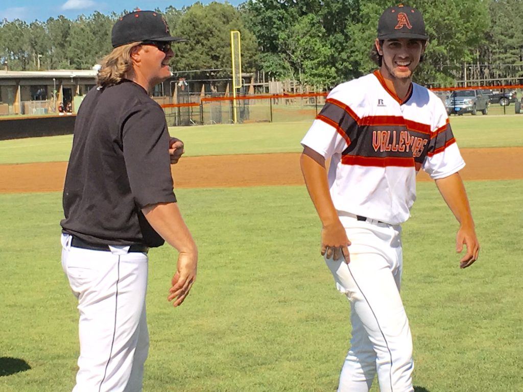 Alexandria pitcher Will Reaves (R) passes assistant coach Zac Welch as he comes off the field after saving the Valley Cubs' 8-6 series-clinching win over Moody. On the cover, Reaves greets the fans as part of the team's post-game victory lap.