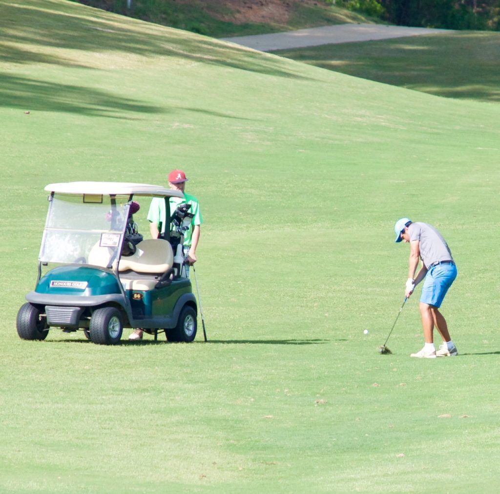 First-round co-leader Erich Egui hits an approach shot on his way to a 69 Saturday. On the cover, Brad Crowe takes a break after posting a 69 to grab a share of the lead. (All photos except cover by B.J. Franklin/GungHo Photos) 