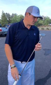 Tournament winner Dalton Chandler admires the borrowed putter that pulled him through in the Oxford City Championship.