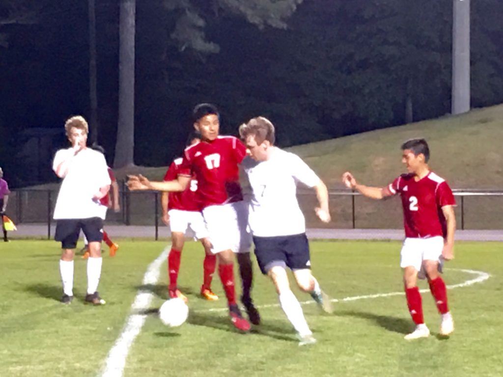 Donoho's Mitchell Baker splits the Collinsville defense during a run in the first half. On the cover, Baker goes way up to play a ball in the air.