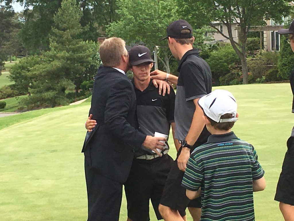 White Plains sophomore Colman Hayes (C) is consoled by Calhoun County schools superintendent Joe Dyar (L) and teammate Layton Bussey after the playoff for 4A North medalist Monday.