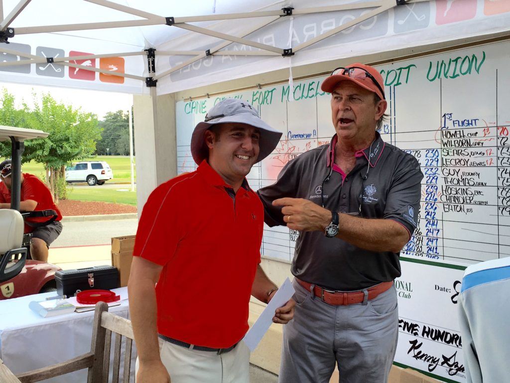 Cane Creek pro Kenny Szuch tells the crowd at the scoreboard Neal Grusczynski (L) came all the way from Milwaukee to play in the event and finished second. He has a local connection: He was Jax State's assistant golf coach last year.
