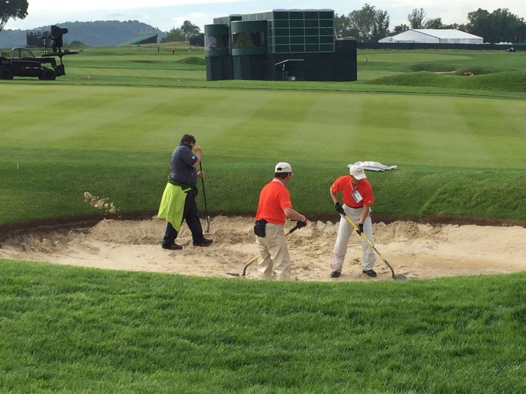 Crews work to restore Oakmont's bunkers after Thursday's heavy rains. On the cover, inside the ropes on No. 3. (Photos by Kenny Szuch via Facebook) 