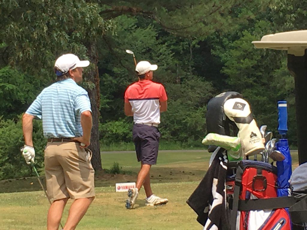 Tournament leader Jimmy Brandt (R) and Jared Davis follow the flight of Brandt's tee shot on 13 Saturday at Cane Creek. On the cover, amateur leader Ty Cole looks for a clear path to the green for his second shot on 18.