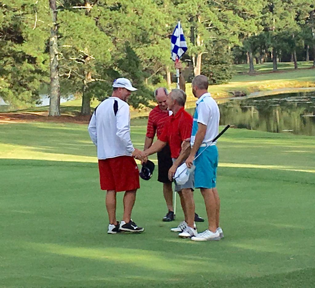 Ty Cole (L) is congratulated by his playing partners (from left) Chip Howell, Jeff Borrelli and Brennan Clay after winning the Pine Hill Invitational Sunday.