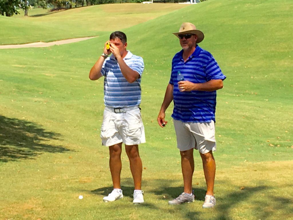 Defending champions Ott (R) and Dalton Chandler check the yardage on a potentially risky shot after missing the green on Mindbreaker 9 Friday. They pulled it off and made birdie to turn in 8-under on the way to a 59. 