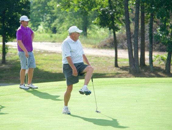 David Martin reacts to his putt approaching the hole as Rob Davie looks on. (Photo by B.J. Franklin/GungHo Photos)