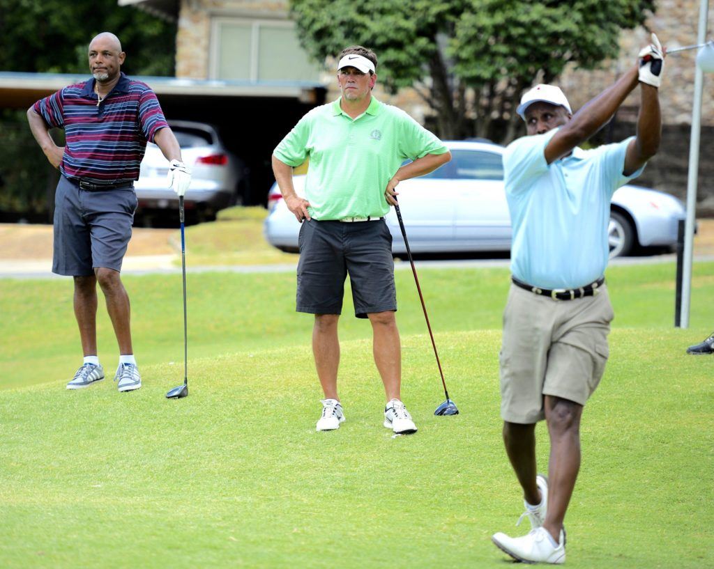 Bernard Snow (L) and Mike Hughston (C) watch Eric Stringer drive off the 17th tee in first flight Acura MDX play at Anniston CC. (Photo by Sandra Howell)