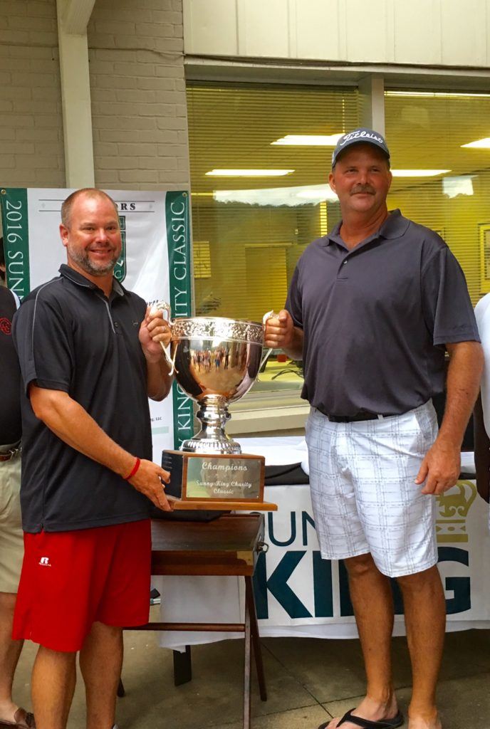 Ty Cole and Gary Wigington hold the Sunny King Charity Classic trophy after winning in record fashion.