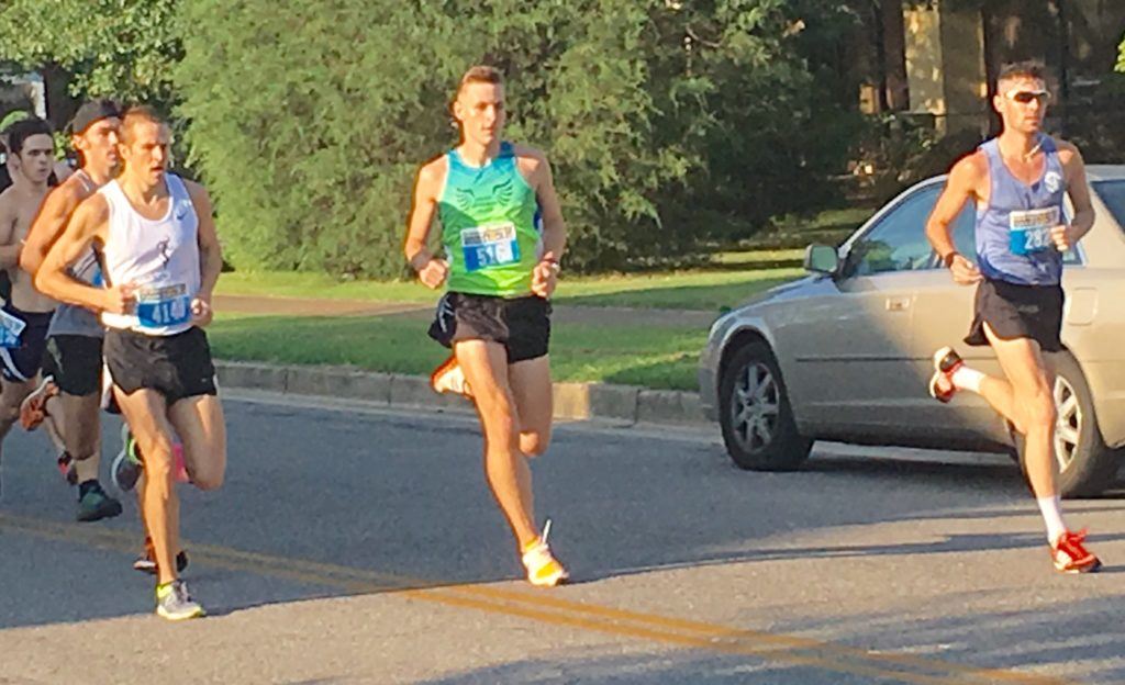 Race winner Jeff Rhodes (L), Donny Barnes of Huntsville and Samuel Mueller of Birmingham lead the Woodstock 5K runners as they come up Christine Avenue. All three finished in the top five.