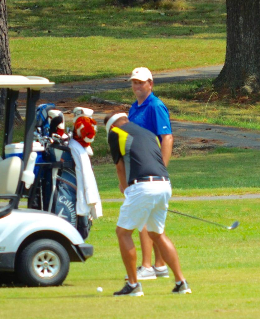 Matt Rogers watches partner Jeremy McGatha hit a shot into the par-5 sixth during Saturday's round of the Highway 9 Challenge. On the cover, defending champion Cory Etter hits his second shot into 16. Below, Marcus Harrell hits his second shot on 16. (Photos by Kurt Duryea)