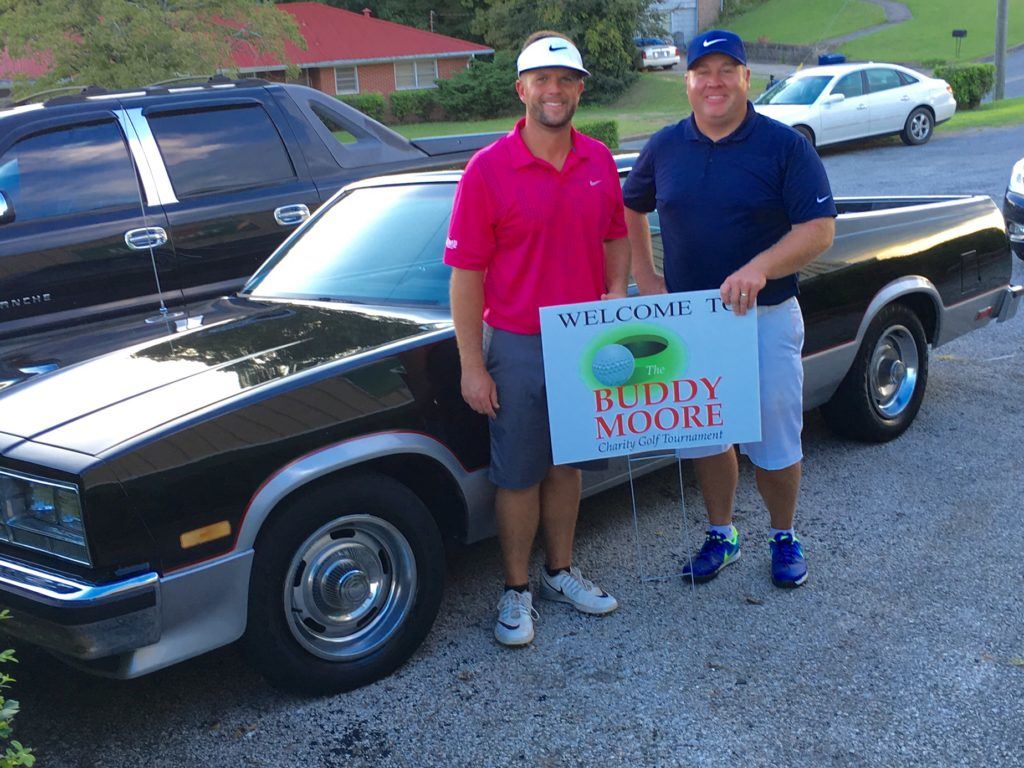 Tournament winners Marcus Harrell (L) and Benji Turley stand in front of Buddy Moore's classic 1986 GMC Caballaro.