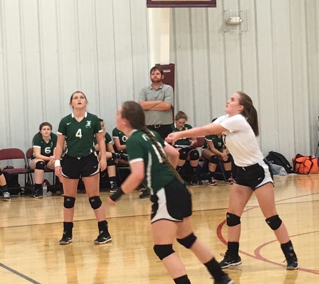 Faith Christian's Abby Kazanjian (R) sends a ball back over the net in the Lady Lions' area match with Sacred Heart Thursday night.