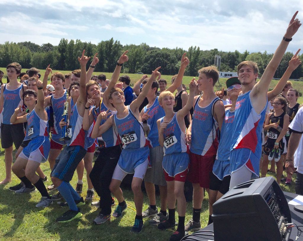 The Pleasant Valley boys cross country team breaks into their happy dance as they collect the winner's trophy Saturday.