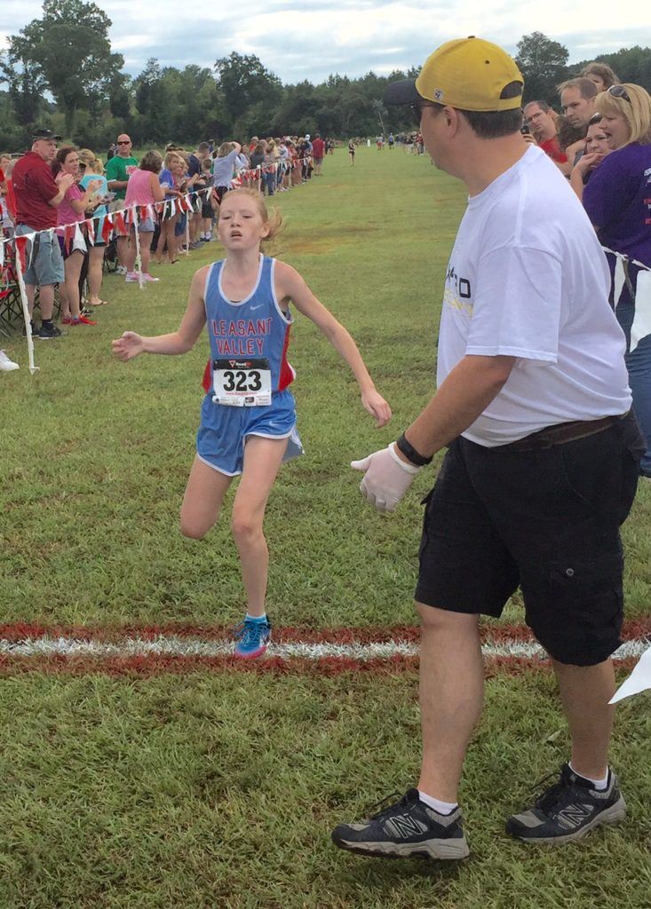 Pleasant Valley's Trinity Roberts comes across the finish line to win the girls race.