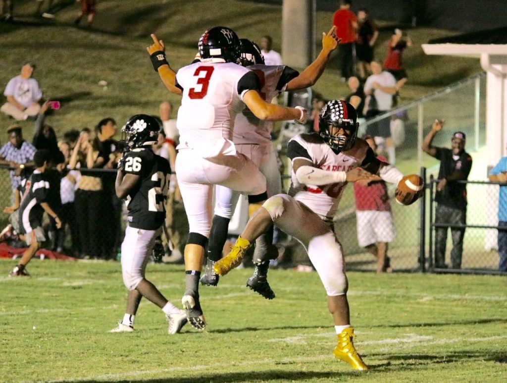 Cody Ortiz (3) celebrates the touchdown Tyrik Hall scored that basically sealed Weaver's win over Wellborn Friday night. On the cover, the Bearcats salute their fans after the historic victory. (All photos by Daniel Lee)