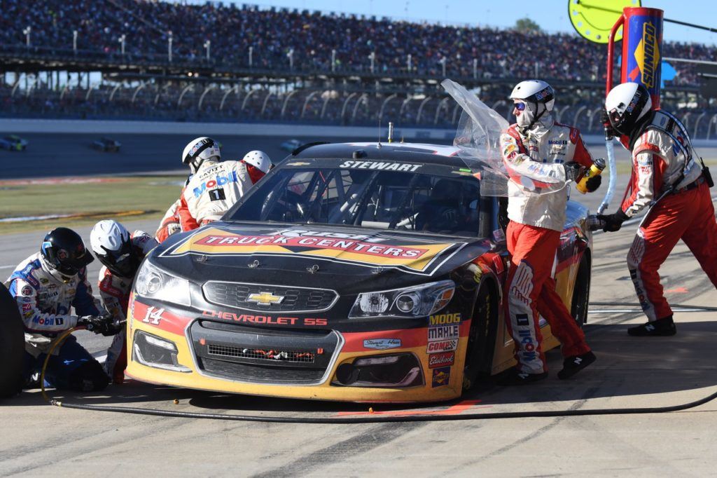 Pit workers clear Tony Stewart's windshield during the driver's final race at Talladega Superspeedway Sunday. The crowd saluted Stewart as he passed the grandstands on Lap 14.