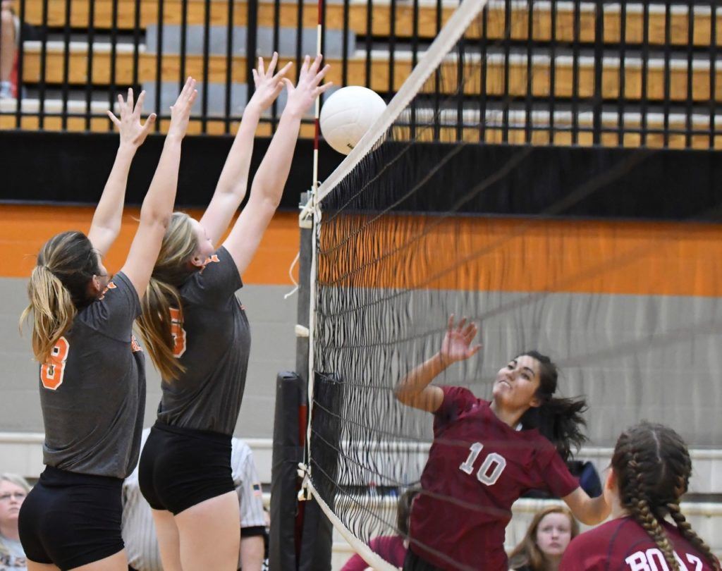 Alexandria's Taylor Spradley and Kendal Bumpus (8) block the ball back over the net in their area championship match against Boaz. (Photo by B.J. Franklin/GungHo Photos)