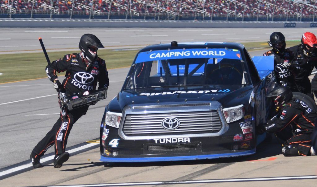 Crew members work quickly to get Christopher Bell out of the pits and back into the race. Bell advanced to the next round of the Truck Series Chase. (Photo by B.J. Franklin/GungHo Photos)