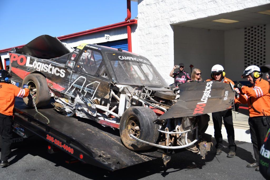 Track workers bring the remains of Ben Rhodes' truck off the wrecker after it got caught up in the biggest incident of the race. Rhodes was running in third  when he got bumped from behind and touched off a wreck that collected 14 trucks. 