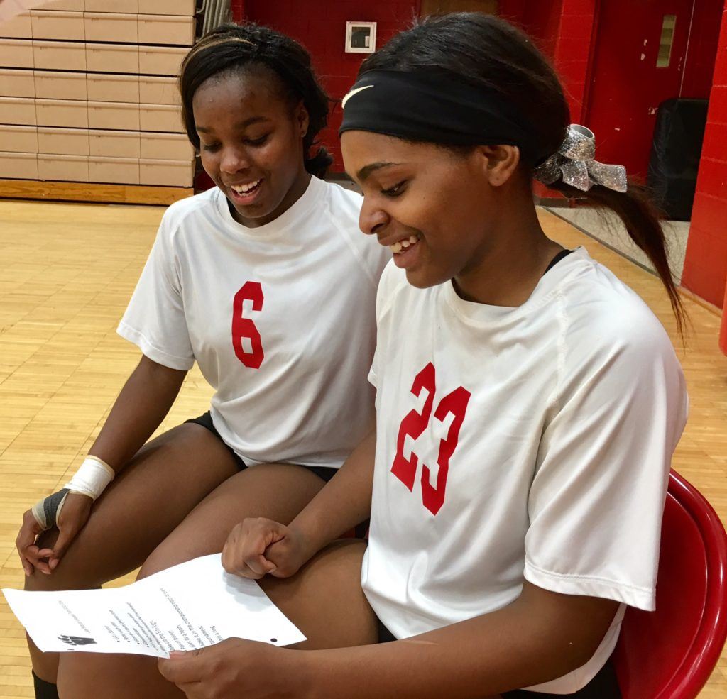 Weaver's Amira Carter (6) and Mariah Thompson look over the team's 2014 goals that are still relevant -- and achievable -- today.