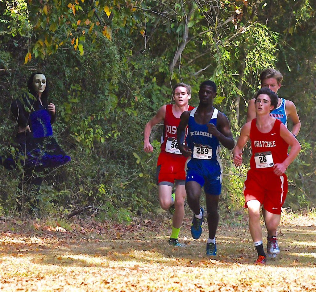 McEachern boys race winner Justin Seymour brings the lead pack past a ghoul in the woods during Ohatchee's Terrortorium 5K at Oxford Lake. Pleasant Valley's Matisse Miller is at the rear; he suffered a leg injury midway through the race. (Photo by B.J. Franklin/GungHo Photos)