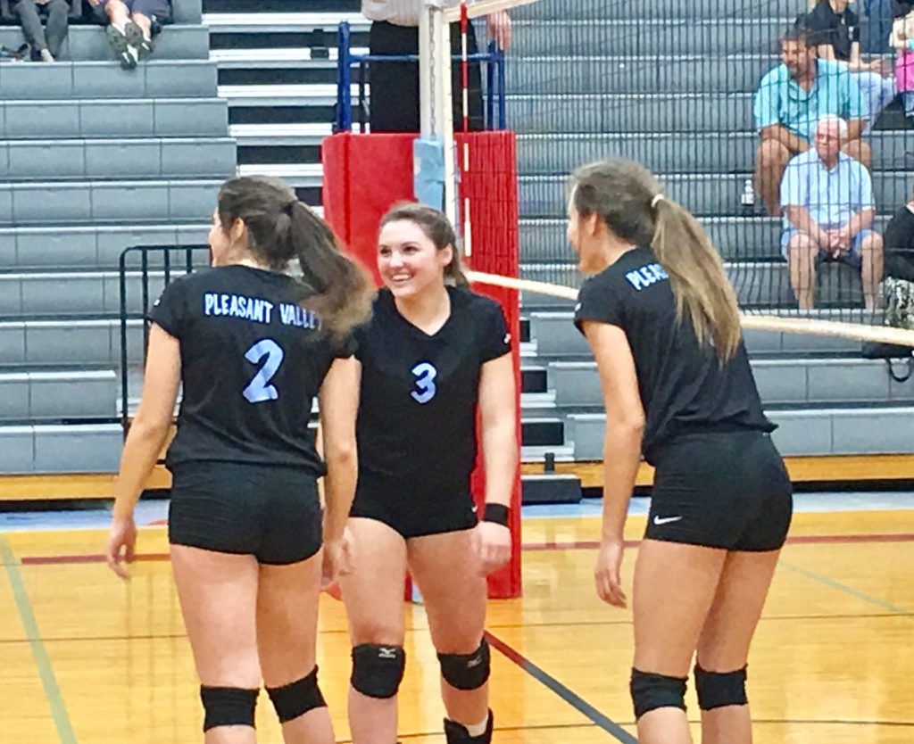 Pleasant Valley setter Anna Bryant (3) shares a laugh on the floor with teammates Alisa St. John (2) an Mikayla Kendrick during Friday's area tournament title match. On the cover, the PV players celebrate with a few pickle-cicles.