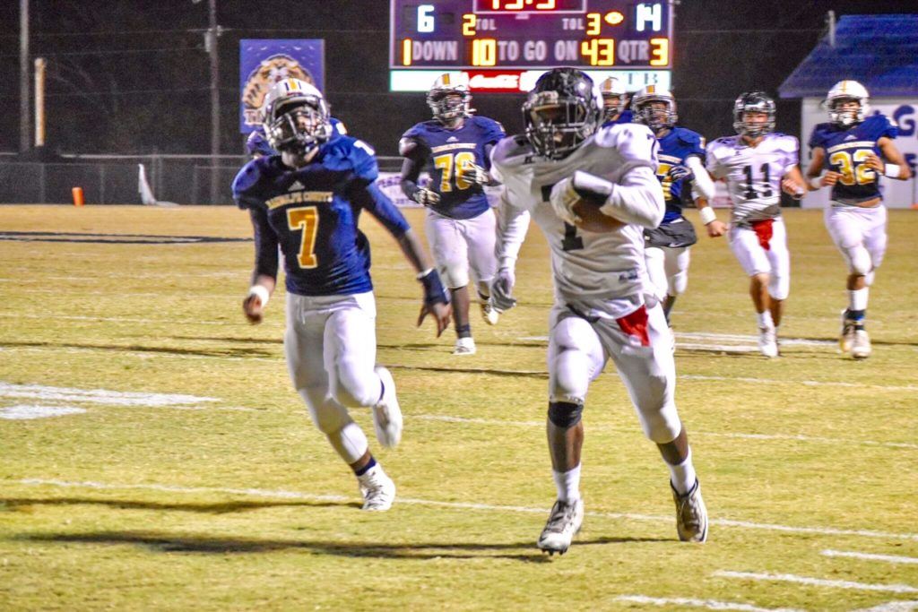 Wellborn's Javian Thomas (R) runs past Randolph County's Damarcus Davis for a touchdown that gave the Panthers a 20-6 lead. On the cover, Randolph County's Seth Hannah scores the first of two fourth-quarter touchdowns that helped bring the Tigers back. (Photos by Jeremy Wortham/Tiger Den Photography)