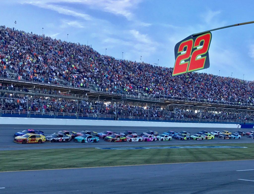 Joey Logano leads the field past his pit stall on the final restart that carried him victory Sunday.