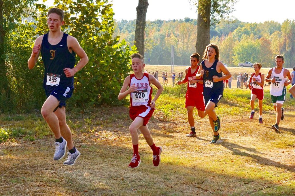 A pack of runners push through the tree line at Oxford Lake Park. The pack includes (from left) Alec Gilbert, Matthew Kennewy, Ben Glass, Joseph Francis, Stephan Ray and Zachary Patterson.