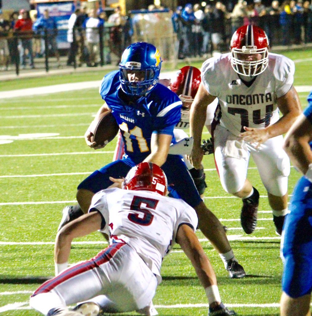 Piedmont quarterback Taylor Hayes (11) went over 3,000 career rushing yards with his first touchdown Friday. On the cover, Cardavion Myers (10) follows Lee Stanley on his long TD run replacing Hayes in the second half. (All photos by Kirk Keener)