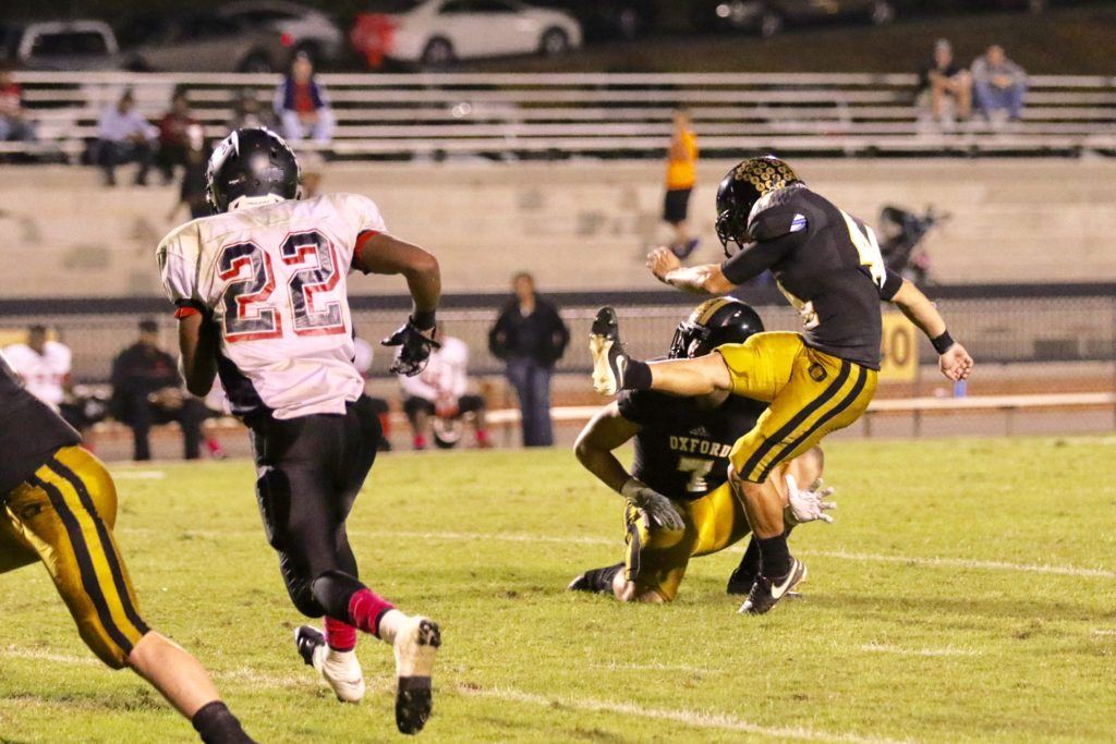 Senior kicker Keaton Borrelli follows through on one of his seven successful kicks against Sumter Central. Borrelli dedicated his effort to his mom, who was celebrating her birthday Friday night. On the cover, quarterback Abe Peoples pulls away from center to get the action going. (All photos by Kristen Stringer/Krisp Pics Photography)