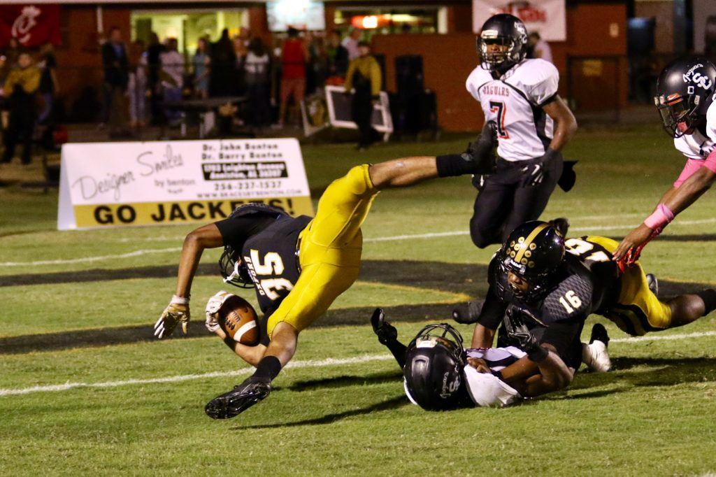 Oxford's Richard Cantrell (35) fights to keep his balance as nears the end zone for his third-quarter touchdown.