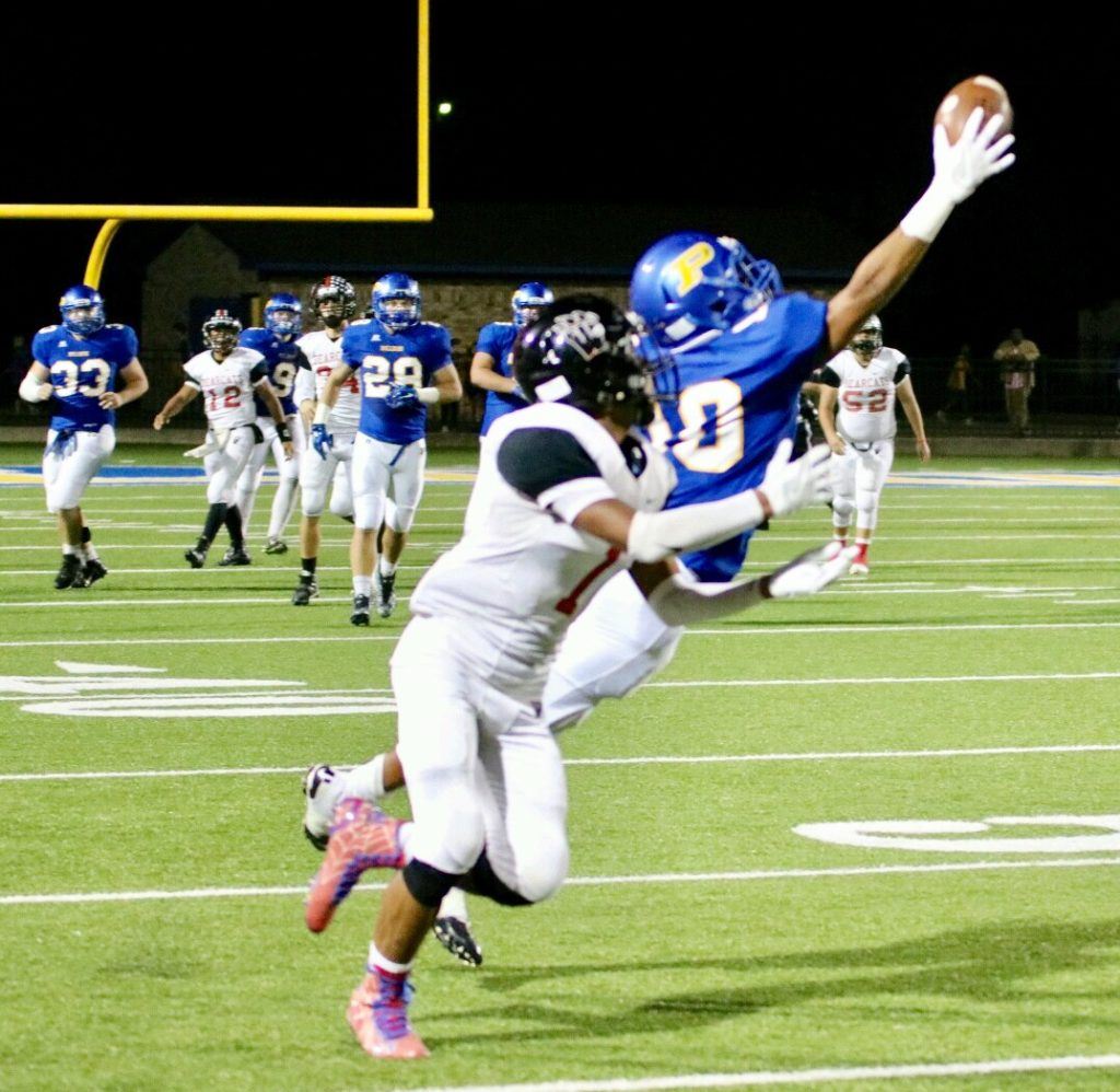 Piedmont's Cardavion Myers (10) stretches to make a one-handed grab in front of Weaver's Maurice Goodman. (Photo by Daniel Lee)