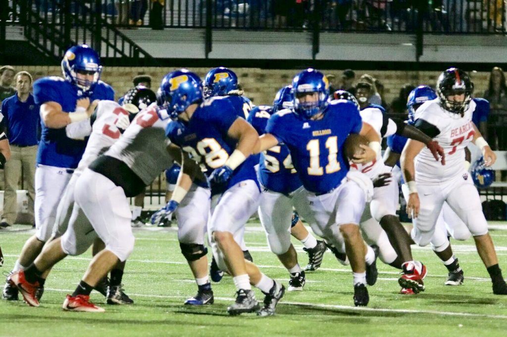 Piedmont quarterback Taylor Hayes (11) follows his blockers against Weaver. Hayes rushed for 86 yards, threw for 239 yards and accounted for four touchdowns. (Photo by Daniel Lee)