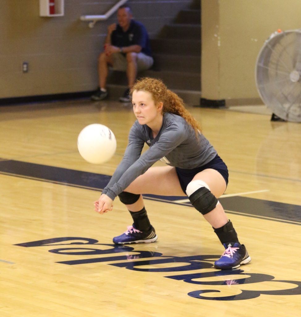 Reagan Stallings reaches down for one of her 45 digs in Jacksonville's county tournament semifinal win over Oxford Saturday. On the cover, the Lady Golden Eagles celebrate getting back into the title match. (Photos by Kristen Stringer/Krisp Pics Photography)