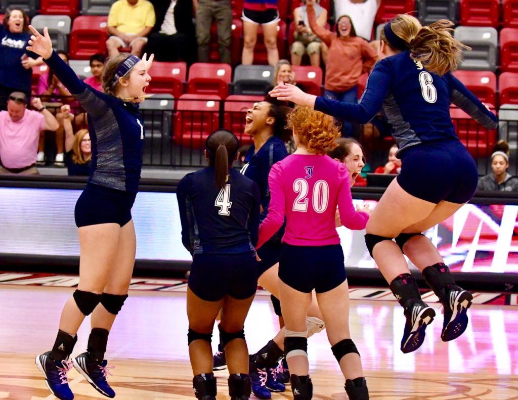 Jacksonville's players celebrate after the winning point drops in Monday's Calhoun County Volleyball Tournament final. 