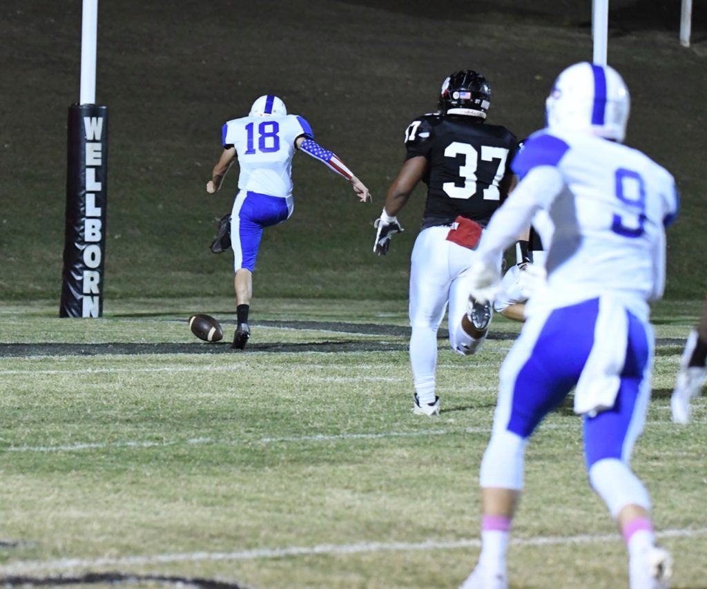 Joseph Harris (37) chases White Plains' Dakota Abramski and the football before recovering the ball in the end zone for another Wellborn defensive touchdown. 