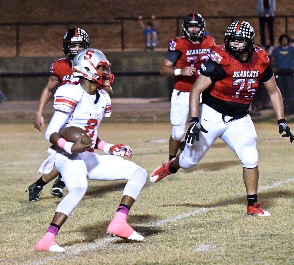 Saks' Laderrick Bell (2) sizes up Weaver's Riley Benavides before deciding where to cut in Friday's game. Both teams are headed to playoff games next week. (Photo by B.J. Franklin/GungHo Photos)