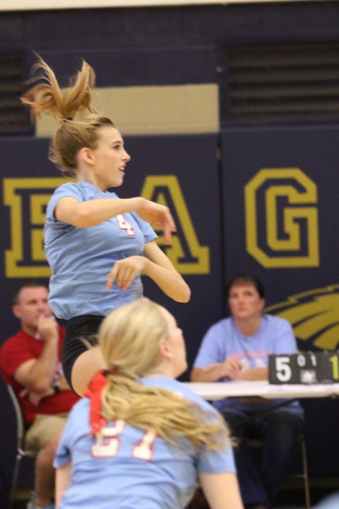 Cammy Cochran (4) plays a shot back across the net in Pleasant Valley's Calhoun County Volleyball Tournament semifinal victory over Alexandria. On the cover, the Lady Raiders celebrate. (Photos by Kristen Stringer/Krisp Pics Photography)