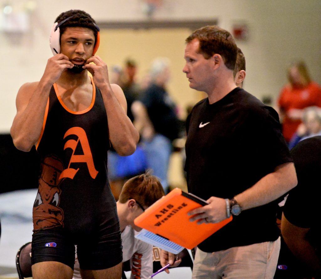 Christian Knop (L) gets some last-minute instructions from Alexandria coach Frank Hartzog before taking the mat for his first high school match of the season. (All photos by B.J. Franklin/GungHo Photos)