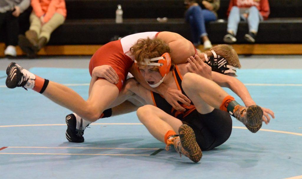 Alexandria's Fletcher Swindall (dark singlet) holds onto Saks' Thomas Brown during their 126-pound match Tuesday night. On the cover, Valley Cubs' senior Gannon Womack makes a move on Lincoln's Marrequis Arnold. (Photos by B.J. Franklin/GungHo Photos)