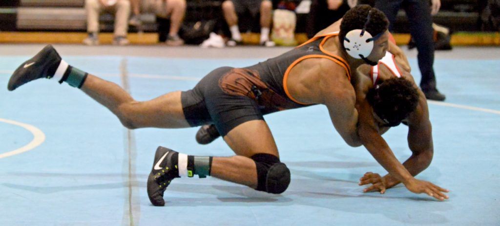 Knop takes Saks' Rodney Reddick to the mat at the start of their match Tuesday night. Below, Knop is congratulated by Reddick after scoring the pin.