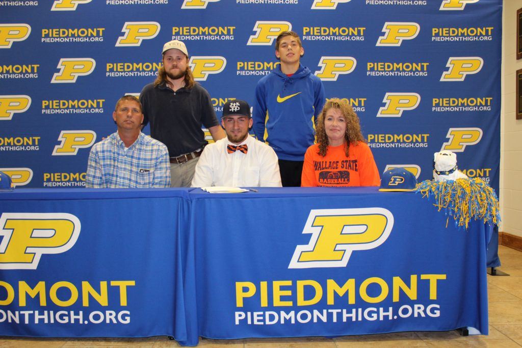 Piedmont senior Easton Kirk (front center) is joined at his signing ceremony by (from left) father Shane, brothers Kyle and Weston, and mother Kellie. (Photo by Shannon Fagan)