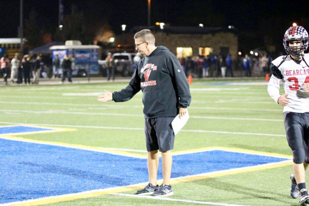 Weaver football coach Daryl Hamby extends a hand at midfield as he awaits a post-game handshake that never came. (Photo by Daniel Lee)