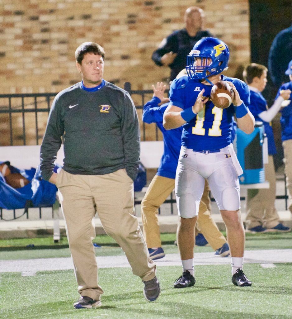 Piedmont quarterback Taylor Hayes warms up under the watchful eye of Bulldogs head coach Steve Smith. Hayes has accounted for 3,116 yards and 50 TDs this season, 7,221 yards and 99 TDs in his career. (Photo by B.J. Franklin/GungHo Photos)