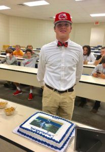 Jacksonville right-hander Colin Casey stands next to the cake that bears his likeness to celebrate signing with Jacksonville State Wednesday.